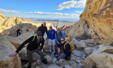Group of hikers exploring Red Rock Canyon during sightseeing tour.