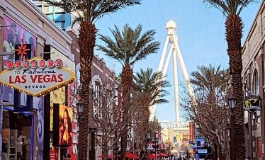 Las Vegas Strip and Downtown with the High Roller Ferris Wheel in the background.