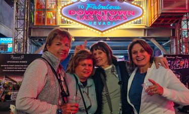 Fremont Street neon sign with visitors at Las Vegas Downtown.