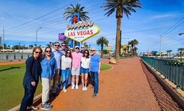 Group of tourists at the iconic Welcome to Fabulous Las Vegas sign.