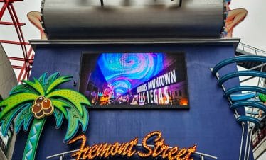 Fremont Street Experience in Las Vegas with vibrant neon signs and lively atmosphere.