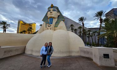 Sphinx statue at Luxor Hotel in Las Vegas with two visitors in front.
