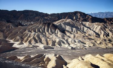 Eroded desert hills in Death Valley during a sunny day.