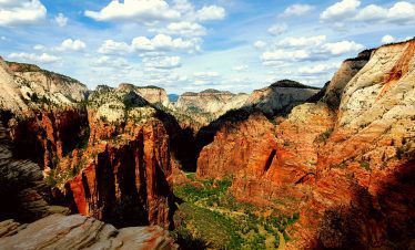 Breathtaking Zion Canyon with colorful cliffs and lush valley below.