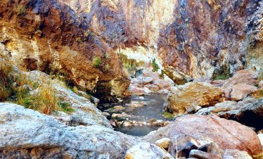 Scenic view of rocky canyon with a small stream flowing through it.