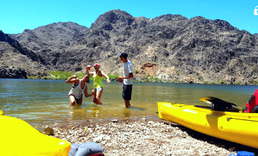 Family enjoying a kayaking adventure at Black Canyon near Hoover Dam.