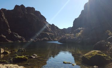 Scenic view of Black Canyon with calm water and rugged cliffs.
