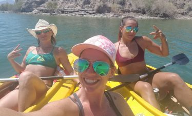 Three women kayaking in Black Canyon with scenic river views.