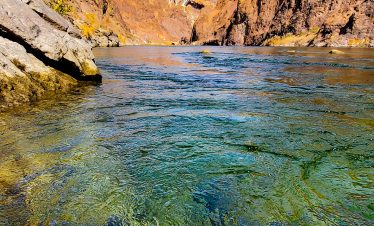 Scenic view of Black Canyon with river and bridge under blue sky.