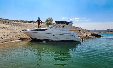 Private boat on Lake Mead with scenic desert background.