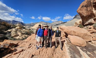 Group of tourists exploring Red Rock Canyon near Las Vegas on a sunny day.
